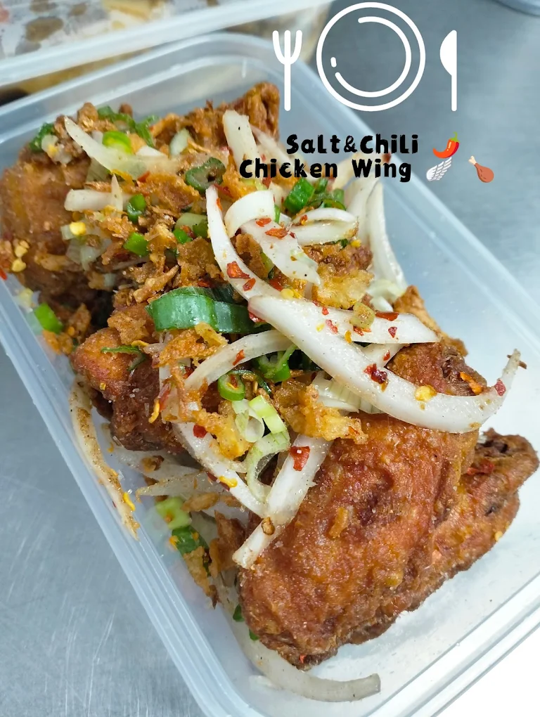 Salt and chilli chicken wings topped with onions, peppers and chilli