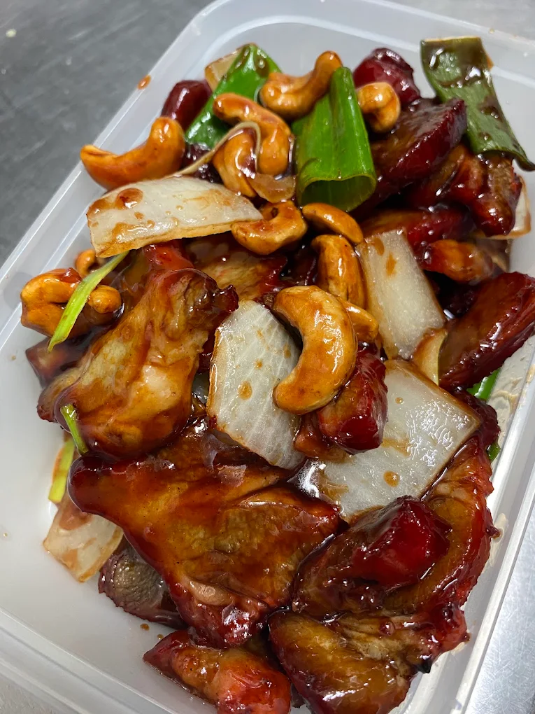 Chicken with cashew nuts and vegetables in a takeaway container